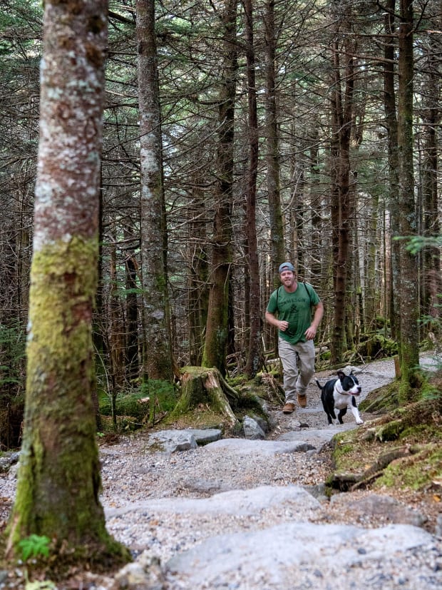 A man and his dog hiking on Black Mountain Crest Trail.