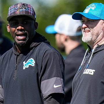 Detroit Lions wide receivers coach Scottie Montgomery, left, talk to offensive coordinator John Morton 