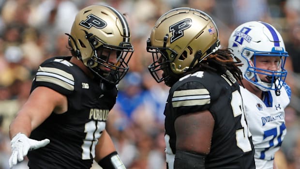 Purdue Boilermakers defensive end Will Heldt (15) celebrates with Purdue Boilermakers defensive lineman Damarjhe Lewis (34) S