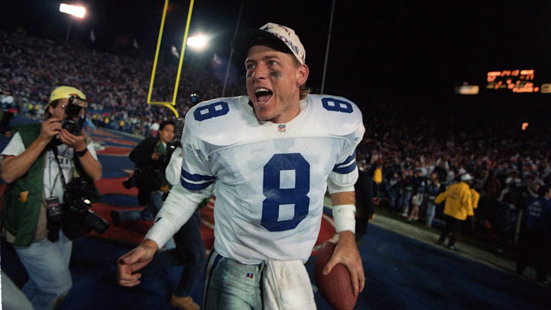 Dallas Cowboys quarterback Troy Aikman celebrates a big win. 