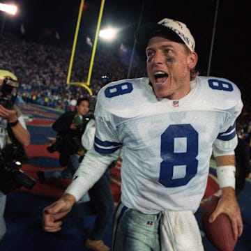 Dallas Cowboys quarterback Troy Aikman celebrates a big win. 