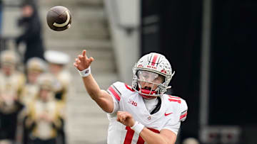 Ohio State Buckeyes quarterback Julian Sayin (10) throws over Purdue Boilermakers defensive lineman Jamarrion Harkless (97) during the NCAA football game at Ross-Ade Stadium in West Lafayette, Ind. on Nov. 8, 2025. Ohio State won 34-10.