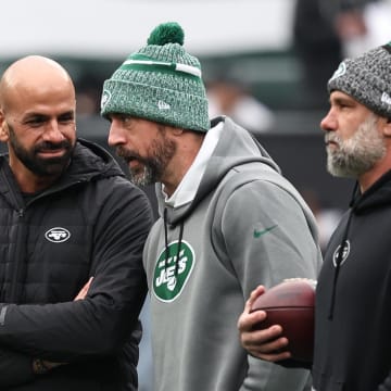 Dec 24, 2023; East Rutherford, New Jersey, USA; New York Jets head coach Robert Saleh (left) talks with quarterback Aaron Rodgers (center) before the game against the Washington Commanders at MetLife Stadium.