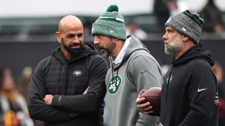 Dec 24, 2023; East Rutherford, New Jersey, USA; New York Jets head coach Robert Saleh (left) talks with quarterback Aaron Rodgers (center) before the game against the Washington Commanders at MetLife Stadium. 