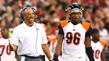 Aug 24, 2014; Glendale, AZ, USA; Cincinnati Bengals defensive line coach Jay Hayes (left) with defensive end Carlos Dunlap (96) against the Arizona Cardinals at University of Phoenix Stadium. Mandatory Credit: Mark J. Rebilas-Imagn Images