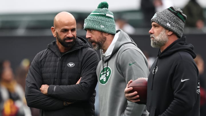 Dec 24, 2023; East Rutherford, New Jersey, USA; New York Jets head coach Robert Saleh (left) talks with quarterback Aaron Rodgers (center) before the game against the Washington Commanders at MetLife Stadium.