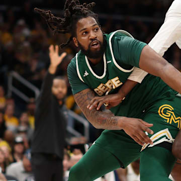 Mar 16, 2025; Washington, D.C., USA; George Mason Patriots forward Jalen Haynes (11) passes the ball as VCU Rams forward Christian Fermin (21) defends in the first half at Capital One Arena. Mandatory Credit: Geoff Burke-Imagn Images