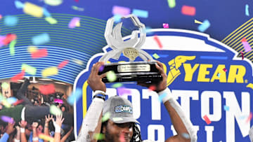 Tulane's Dorian Williams hoists his \"Outstanding Defensive Player\" trophy during the celebration after Tulane defeated USC during the 87th Goodyear Cotton Bowl Classic at AT&T Stadium on Monday, January 2, 2023.

COTTONBOWL

Syndication Times Record News