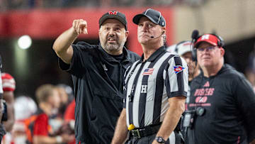 Nebraska head coach Matt Rhule points out something on the scoreboard to a referee during the Illinois game.