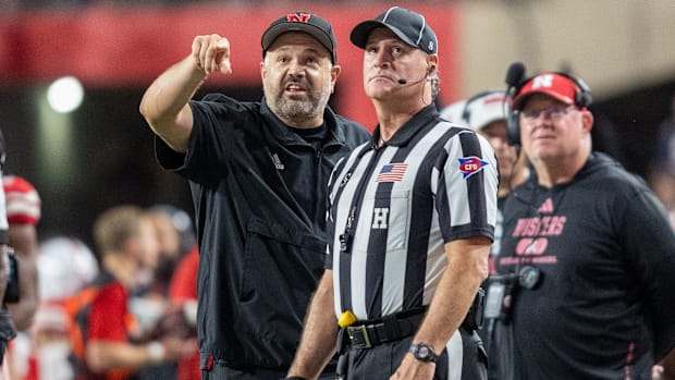 Nebraska Head Coach Matt Rhule points out something on the scoreboard to a referee during the Illinois game.