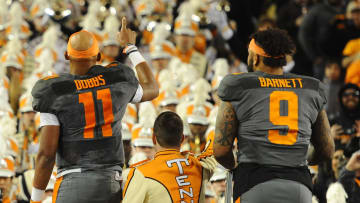 Dec 30, 2016; Nashville , TN, USA; Tennessee Volunteers quarterback Joshua Dobbs (11) and defensive end Derek Barnett (9) lead the band after a win against the Nebraska Cornhuskers at Nissan Stadium. Tennessee won 38-24. Mandatory Credit: Christopher Hanewinckel-USA TODAY Sports