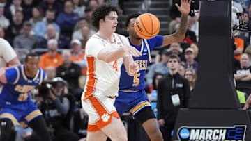 Mar 20, 2025; Providence, RI, USA; Clemson Tigers forward Ian Schieffelin (4) passes th ball against McNeese State Cowboys forward Joe Charles (5) during the first half at Amica Mutual Pavilion. Mandatory Credit: Gregory Fisher-Imagn Images