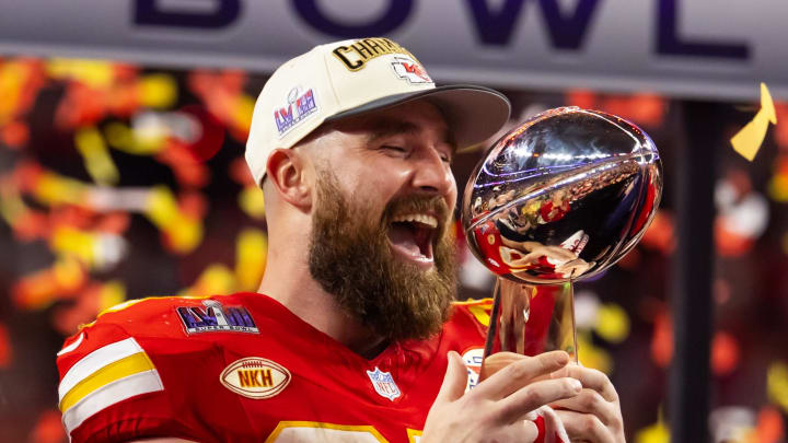 Feb 11, 2024; Paradise, Nevada, USA; Kansas City Chiefs tight end Travis Kelce (87) celebrates with the Vince Lombardi Trophy after defeating the San Francisco 49ers in Super Bowl LVIII at Allegiant Stadium. 