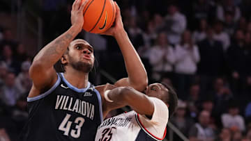 Mar 13, 2025; New York, NY, USA;  Villanova Wildcats forward Eric Dixon (43) shoots over Connecticut Huskies center Samson Johnson (35) during the second half at Madison Square Garden. Mandatory Credit: Robert Deutsch-Imagn Images