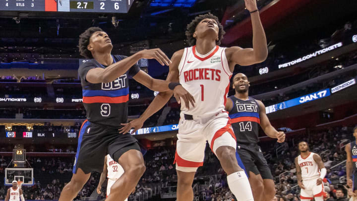 Jan 12, 2024; Detroit, Michigan, USA; Detroit Pistons forward Ausar Thompson (9) battles for for the ball with his twin brother Houston Rockets forward Amen Thompson (1) during the first half at Little Caesars Arena. Mandatory Credit: David Reginek-USA TODAY Sports