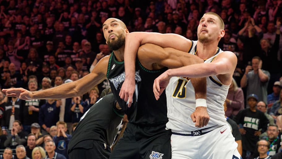 Timberwolves center Rudy Gobert and Nuggets center Nikola Jokić battle for position.