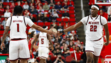 Dec 6, 2025; Raleigh, North Carolina, USA; NC State Wolfpack forward Darrion Williams (1) and forward Ven-Allen Lubin (22) high-five during the second half of the game against the Liberty Flames at Lenovo Center. Mandatory Credit: Jaylynn Nash-Imagn Images
