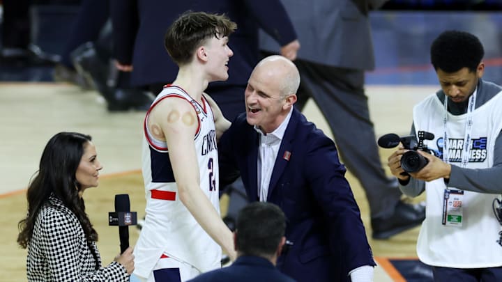 Apr 4, 2026; Indianapolis, IN, USA; UConn Huskies guard Braylon Mullins (24) and UConn Huskies head coach Dan Hurley celebrate after defeating the Illinois Fighting Illini in a semifinal of the Final Four of the men's 2026 NCAA Tournament at Lucas Oil Stadium. Mandatory Credit: Trevor Ruszkowski-Imagn Images