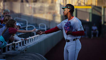 Arizona Diamondbacks third base prospect LuJames Groover signs a ball for a young fan in the Arizona Fall League