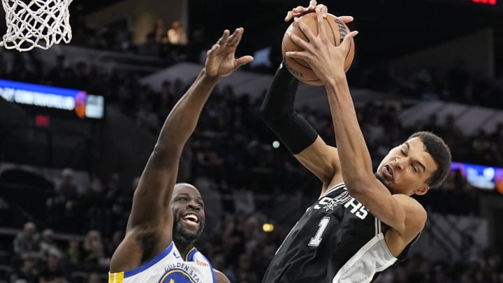 Mar 11, 2024; San Antonio, Texas, USA; San Antonio Spurs forward Victor Wembanyama (1) grabs a rebound over Golden State Warriors forward Draymond Green (23). Mar 11, 2024; San Antonio, Texas, USA; San Antonio Spurs forward Victor Wembanyama (1) grabs a rebound over Golden State Warriors forward Draymond Green (23).