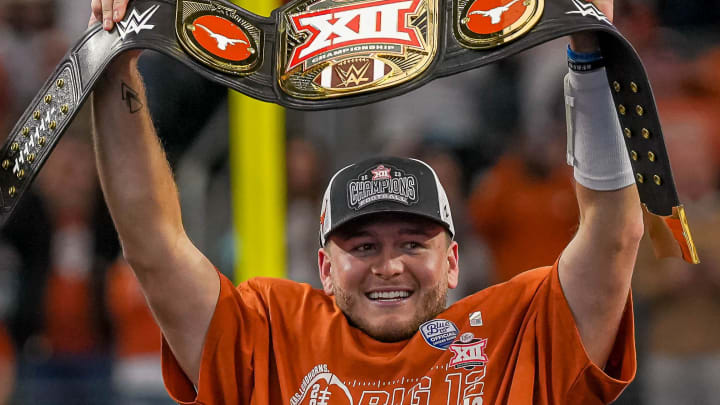 Texas Longhorns quarterback Quinn Ewers (3) holds up the Big 12 Championship belt after the 49-21 win over the Oklahoma State Cowboys at AT&T stadium on Saturday, Dec. 2, 2023 in Arlington.