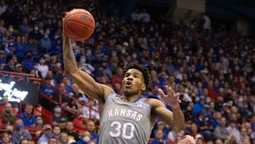 Kansas senior guard Ochai Agbaji (30) leaps up for a dunk over Nevada during the second half of