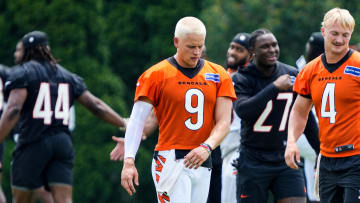 Cincinnati Bengals quarterback Joe Burrow (9) sports a new hair cut while warming up with Rocky Lombardi (4) during the first day of training camp at the Kettering Health Practice Fields outside of Paycor Stadium Wednesday, July 24, 2024.