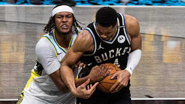 Indiana Pacers' Myles Turner and Milwaukee Bucks star Giannis Antetokounmpo battle for the ball during the 2025 NBA Playoffs