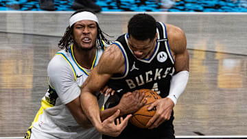 Indiana Pacers center Myles Turner and Milwaukee Bucks forward Giannis Antetokounmpo fight for the ball during the NBA Playoffs. 