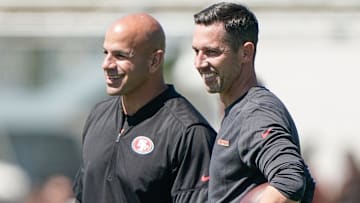 San Francisco 49ers defensive coordinator Robert Saleh smiles alongside head coach Kyle Shanahan as they watch players participate during training camp at the SAP Performance Facility. Mandatory Credit: Stan Szeto-Imagn Images