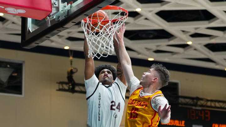 Louisville guard Chucky Hepburn (24) dunks the ball against Calgary