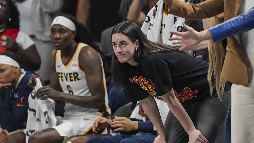Sep 18, 2025; College Park, Georgia, USA; Indiana Fever guard Caitlin Clark (black shirt) watches from the bench during the game against the Atlanta Dream during the second half during game three of round one for the 2025 WNBA Playoffs at Gateway Center Arena at College Park. Mandatory Credit: Dale Zanine-Imagn Images
