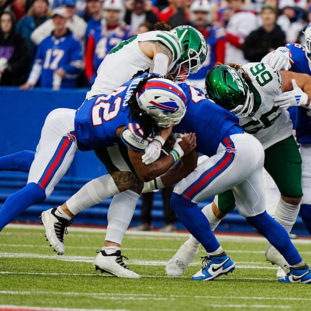 linebacker Dorian Williams (42) and linebacker Joe Andreessen (44) tackle ball carrier