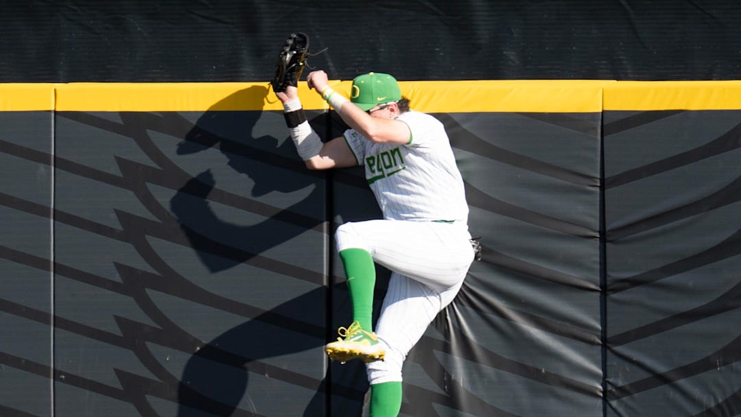 In addition to leading the nation in home runs, Mason Neville (and his outfield partner Anson Aroz can do it with the leather. Here he runs a Michigan player of an extra-base hit at the wall. 