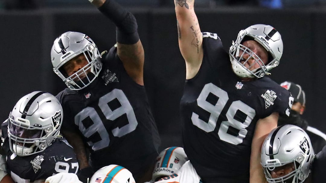 Las Vegas Raiders defensive end Arden Key (99) and Maxx Crosby (98) against the Miami Dolphins at Allegiant Stadium in a 2020 game.