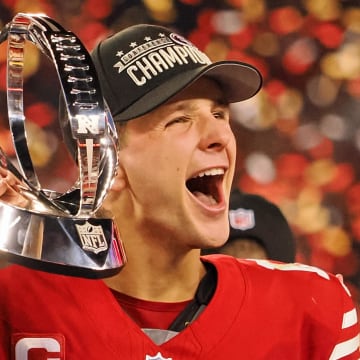 Jan 28, 2024; Santa Clara, California, USA; San Francisco 49ers quarterback Brock Purdy (13) holds the George Halas Trophy while after winning the NFC Championship football game against the Detroit Lions at Levi's Stadium. Mandatory Credit: Kelley L Cox-USA TODAY Sports