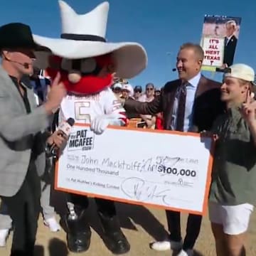 Texas Tech student celebrates winning Pat McAfee’s kicking contest with mascot Raider Red and Kirk Herbstreit.