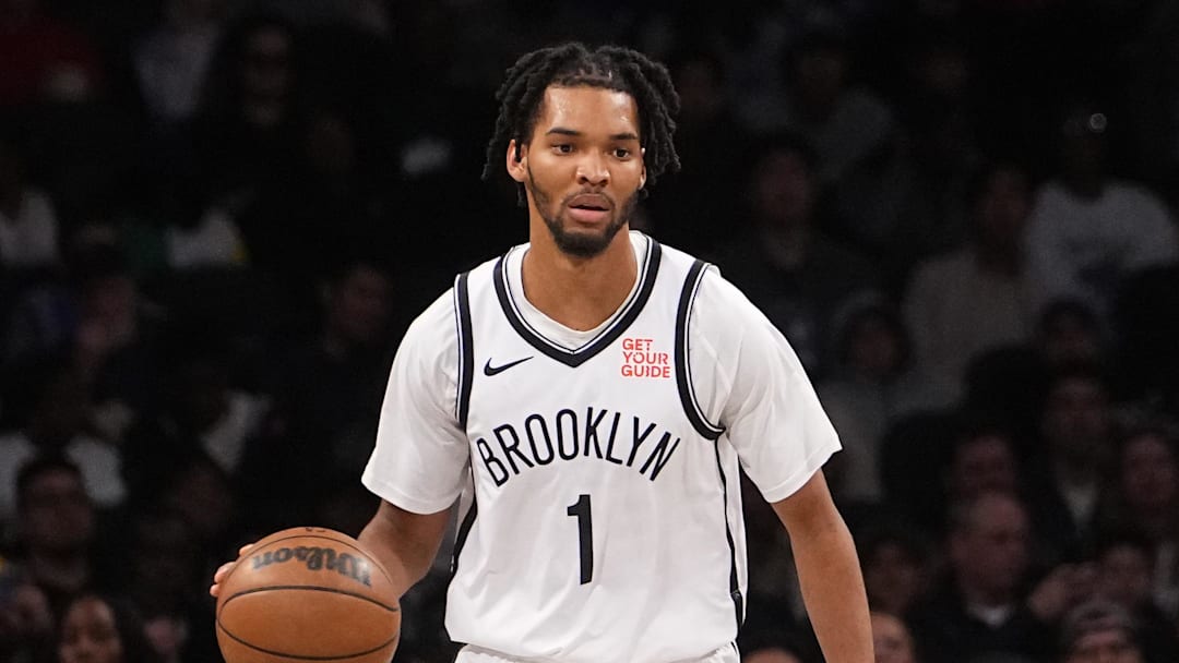 Oct 18, 2024; Brooklyn, New York, USA; Brooklyn Nets forward Ziaire Williams (1) dribbles the ball against Toronto Raptors power forward Chris Boucher (25) during the first half at Barclays Center. Mandatory Credit: Gregory Fisher-Imagn Images