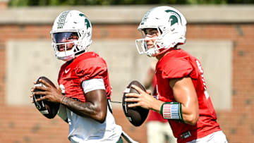 Michigan State's quarterback Aidan Chiles, left, and Alessio Milivojevic look to throw during football practice on Monday, Aug. 11, 2025, in East Lansing.