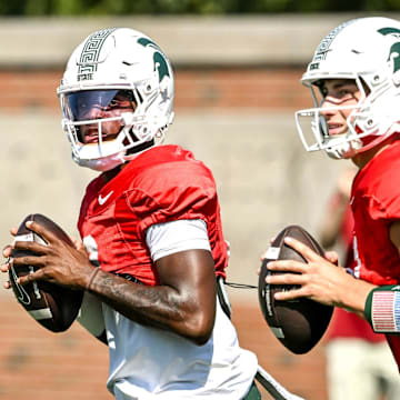 Michigan State's quarterback Aidan Chiles, left, and Alessio Milivojevic look to throw during football practice on Monday, Aug. 11, 2025, in East Lansing.