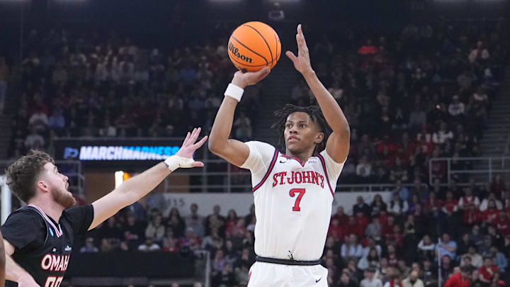 Mar 20, 2025; Providence, RI, USA;  St. John's basketball guard Simeon Wilcher (7) controls the ball against Omaha Mavericks guard Tony Osburn (32) during the first half at Amica Mutual Pavilion.