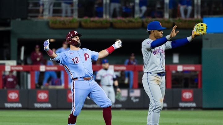 May 16, 2024; Philadelphia, Pennsylvania, USA; Philadelphia Phillies designated hitter Kyle Schwarber (12) reacts behind New York Mets shortstop Francisco Lindor (12) after his RBI double during the seventh inning at Citizens Bank Park. Mandatory Credit: Bill Streicher-Imagn Images