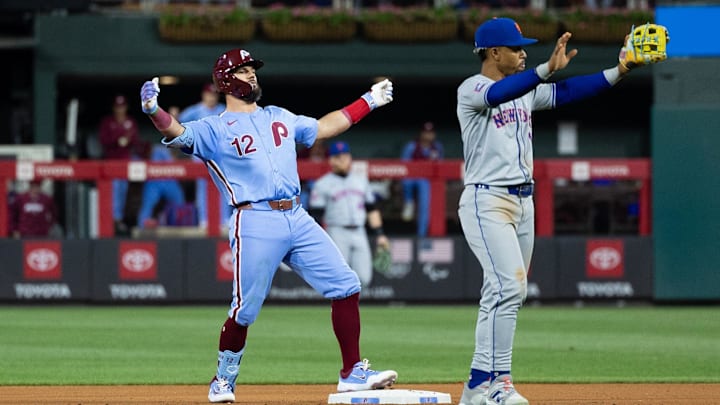 May 16, 2024; Philadelphia, Pennsylvania, USA; Philadelphia Phillies designated hitter Kyle Schwarber (12) reacts behind New York Mets shortstop Francisco Lindor (12) after his RBI double during the seventh inning at Citizens Bank Park. Mandatory Credit: Bill Streicher-Imagn Images