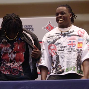 Amari Latimer commits to the University of Wisconsin at Sandy Creek High School. Pictured to his left is his father (Gee Latimer) and pictured to his right is his older brother (Geimer Latimer) 