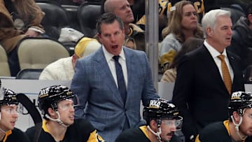 Nov 30, 2024; Pittsburgh, Pennsylvania, USA;  Pittsburgh Penguins head coach Mike Sullivan (rear) reacts on the bench against the Calgary Flames during the third period  at PPG Paints Arena. Mandatory Credit: Charles LeClaire-Imagn Images