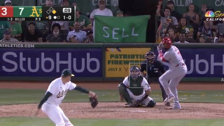 An Oakland A’s fan holds up a sign that says “SELL."