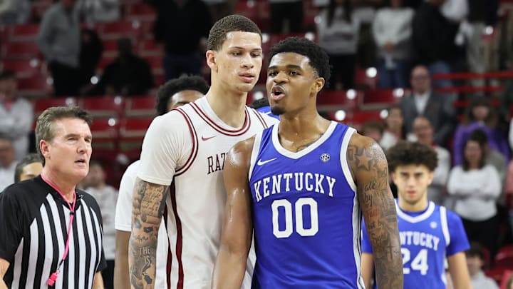 Jan 31, 2026; Fayetteville, Arkansas, USA; Arkansas Razorbacks forward Trevon Brazile (7) and Kentucky Wildcats guard Otega Oweh (00) exchange words during the second half at Bud Walton Arena. Kentucky won 85-77. Mandatory Credit: Nelson Chenault-Imagn Images