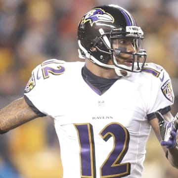 Jan 3, 2015; Pittsburgh, PA, USA; Baltimore Ravens wide receiver Jacoby Jones (12) returns a kick-off against the Pittsburgh Steelers during the first quarter in the 2014 AFC Wild Card playoff football game at Heinz Field. The Ravens won 30-17. Mandatory Credit: Charles LeClaire-Imagn Images