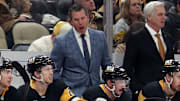 Nov 30, 2024; Pittsburgh, Pennsylvania, USA;  Pittsburgh Penguins head coach Mike Sullivan (rear) reacts on the bench against the Calgary Flames during the third period  at PPG Paints Arena. Mandatory Credit: Charles LeClaire-Imagn Images