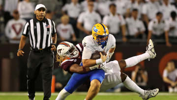 Sep 30, 2023; Blacksburg, Virginia, USA; Pittsburgh Panthers quarterback Phil Jurkovec (5) is sacked by Virginia Tech Hokies defensive lineman Pheldarius Payne (0) during the fourth quarter at Lane Stadium. Mandatory Credit: Peter Casey-USA TODAY Sports